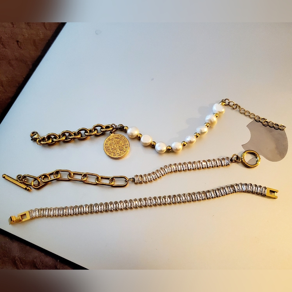 Three costume jewelry bracelets